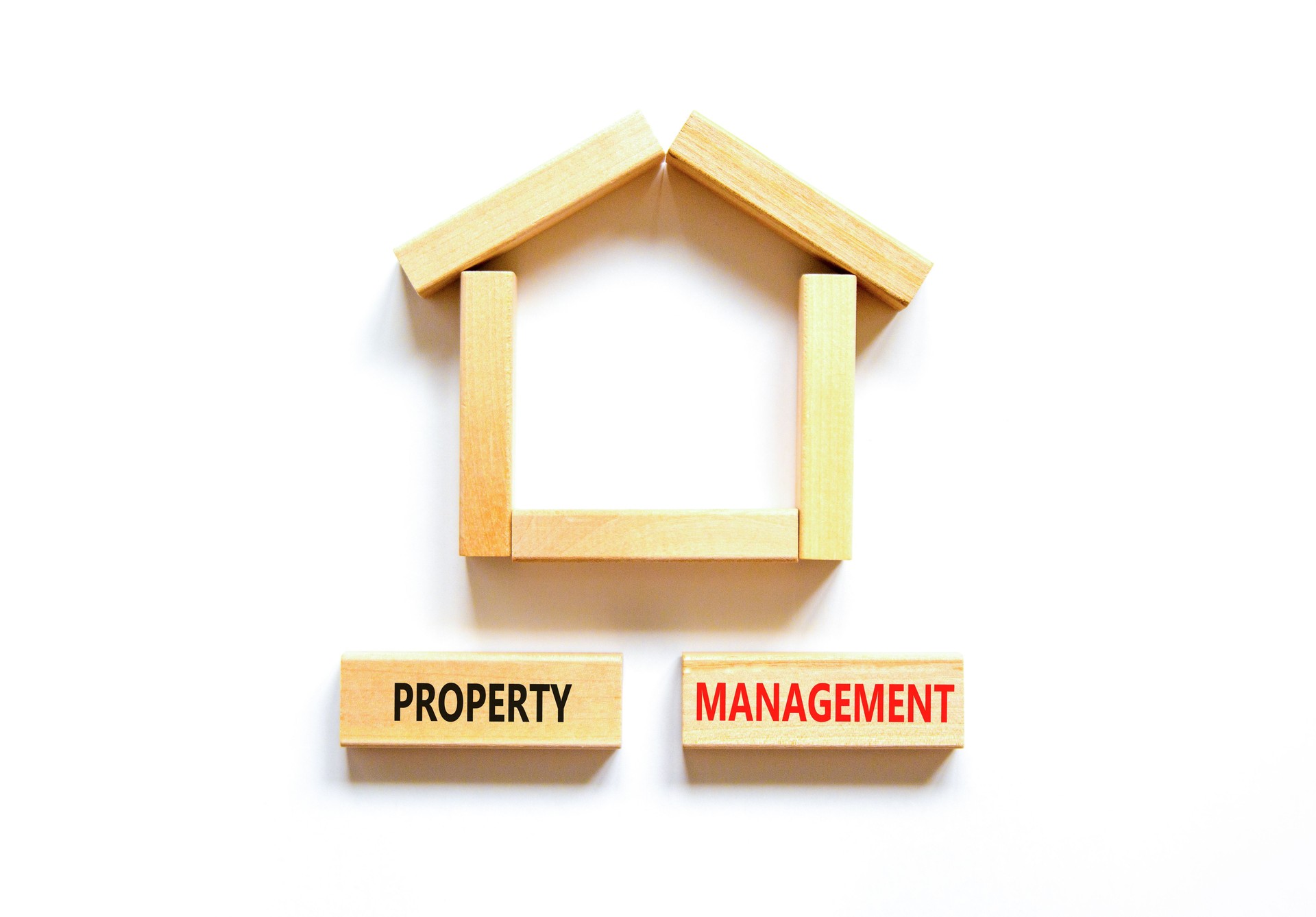 Property management symbol. Concept words Property management on wooden blocks on a beautiful white table white background. Wooden house model. Business property management concept. Copy space.