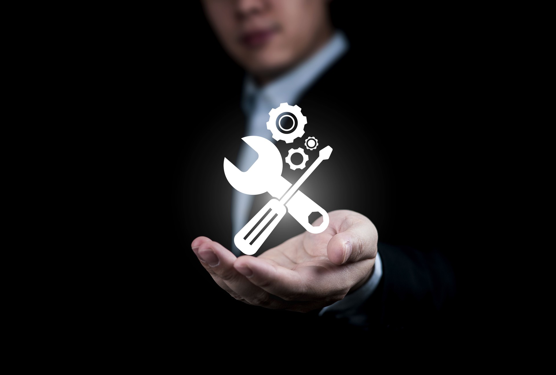 Man showing maintenance icon with gear on hand.